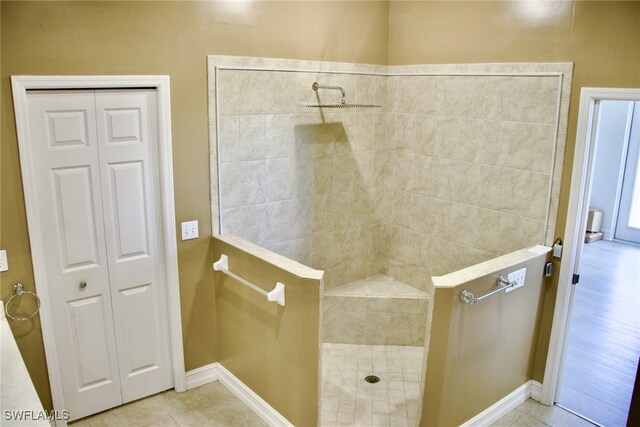 bathroom featuring a tile shower and hardwood / wood-style floors