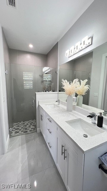 bathroom with a shower with door and vanity