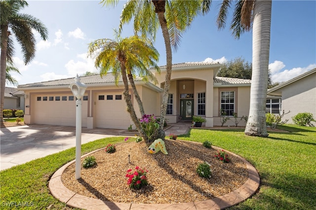 mediterranean / spanish house featuring a garage and a front lawn