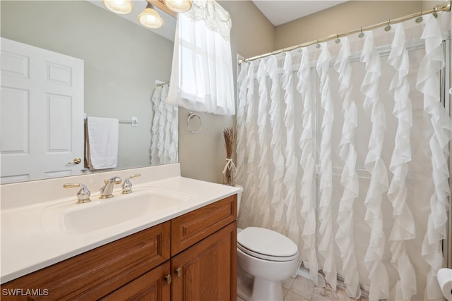 bathroom featuring vanity, tile patterned floors, and toilet