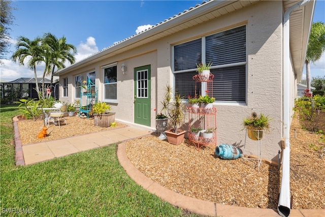 property entrance with a yard