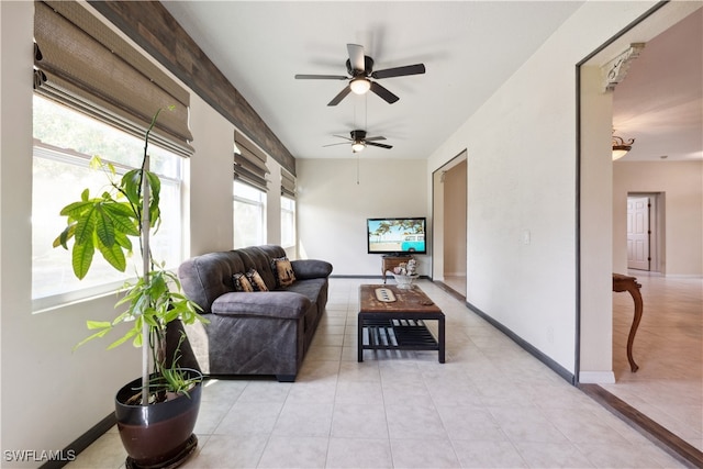 tiled living room featuring ceiling fan