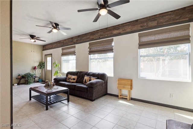 living room with ceiling fan and light tile patterned flooring