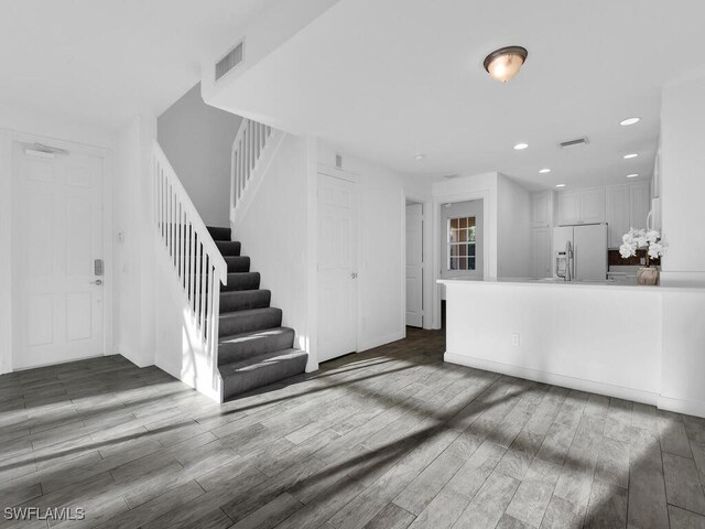 unfurnished living room with dark hardwood / wood-style flooring