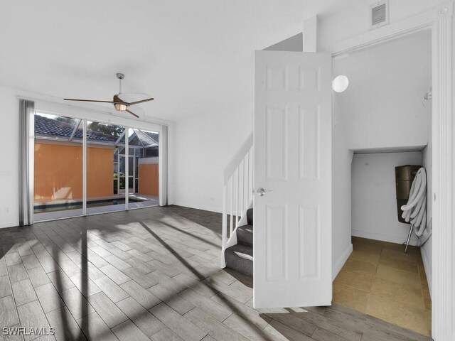 interior space with ceiling fan and wood-type flooring