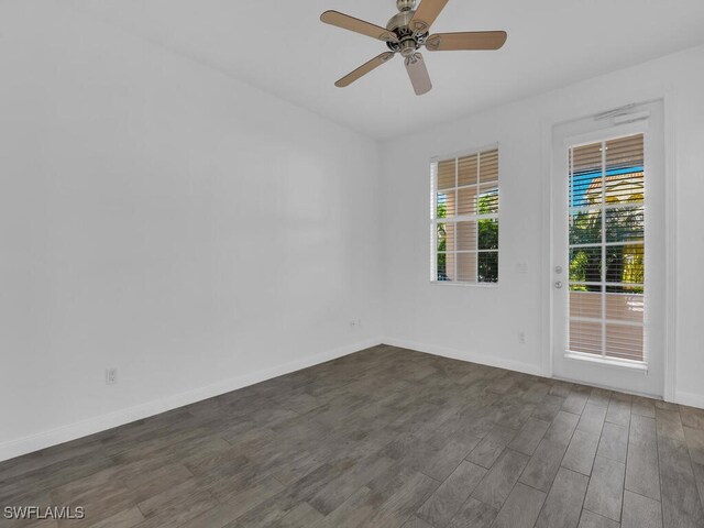 unfurnished room with dark wood-type flooring and ceiling fan