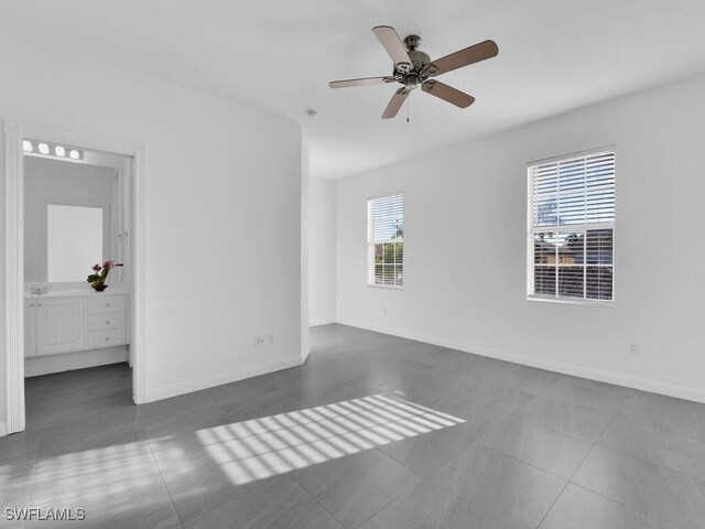 tiled empty room featuring a wealth of natural light and ceiling fan