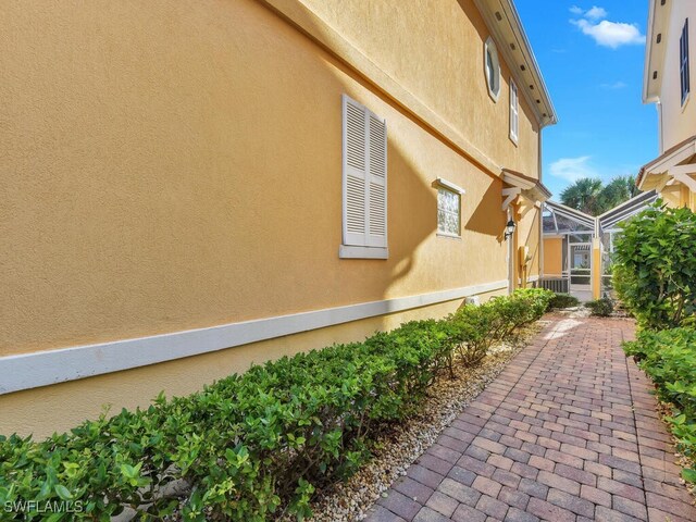 view of side of home featuring a lanai