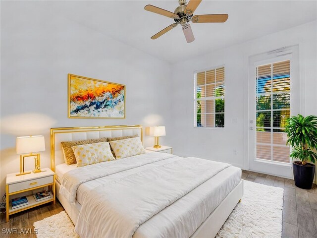 bedroom with ceiling fan, access to outside, and wood-type flooring