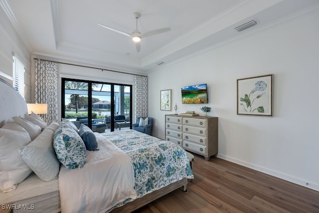 bedroom with access to outside, a tray ceiling, wood-type flooring, crown molding, and ceiling fan