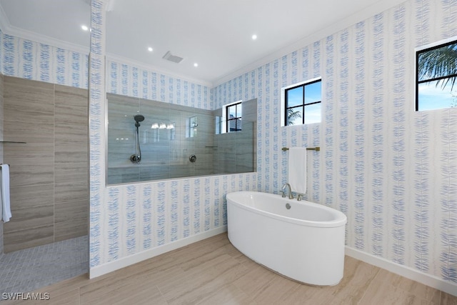 bathroom with independent shower and bath, crown molding, and hardwood / wood-style flooring