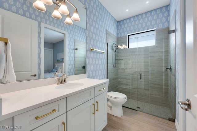 bathroom featuring toilet, hardwood / wood-style floors, vanity, a chandelier, and walk in shower