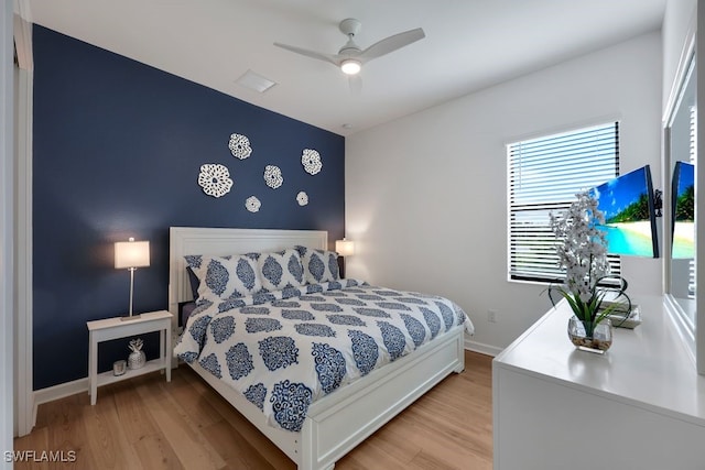 bedroom with light hardwood / wood-style floors and ceiling fan