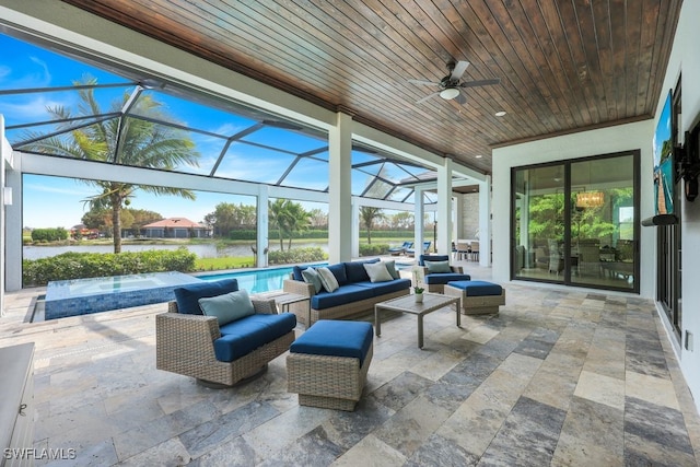 view of patio / terrace featuring outdoor lounge area, ceiling fan, a water view, and a lanai