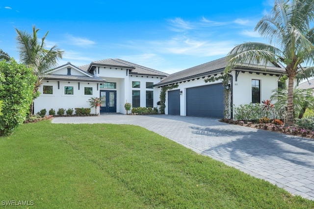 view of front of house with a garage and a front lawn