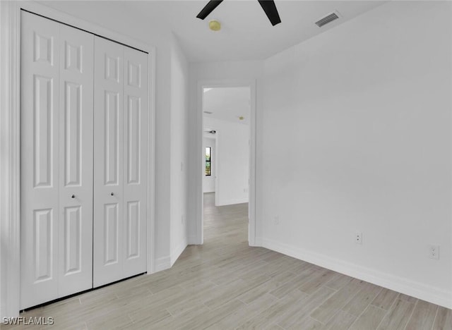 interior space with a closet, light hardwood / wood-style flooring, and ceiling fan