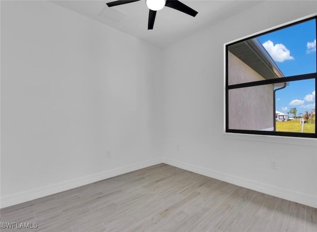 spare room featuring ceiling fan and light hardwood / wood-style floors