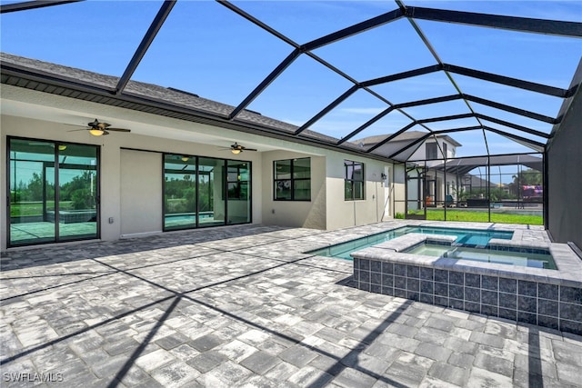 view of pool with ceiling fan, glass enclosure, an in ground hot tub, and a patio area