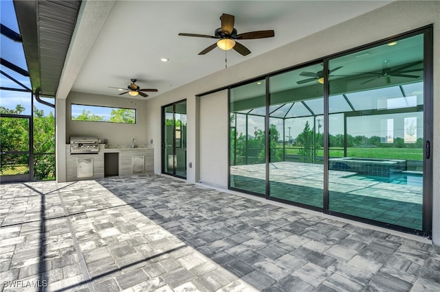 view of patio / terrace with area for grilling, glass enclosure, ceiling fan, and sink