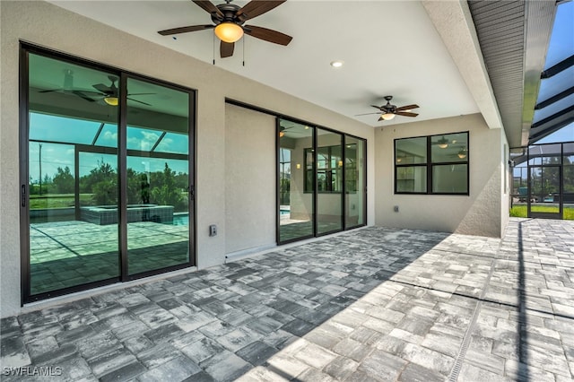 view of patio / terrace with ceiling fan and glass enclosure