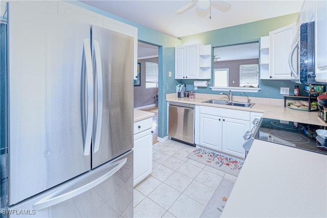 kitchen featuring sink, ceiling fan, stainless steel appliances, white cabinets, and light tile patterned floors