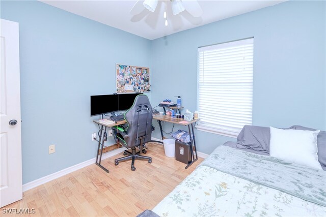 bedroom with hardwood / wood-style floors and ceiling fan