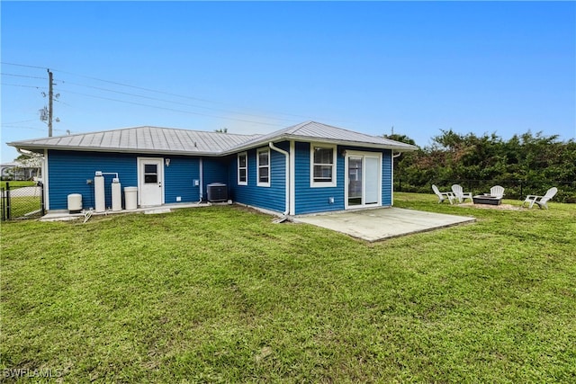 back of property with a patio, central air condition unit, and a lawn