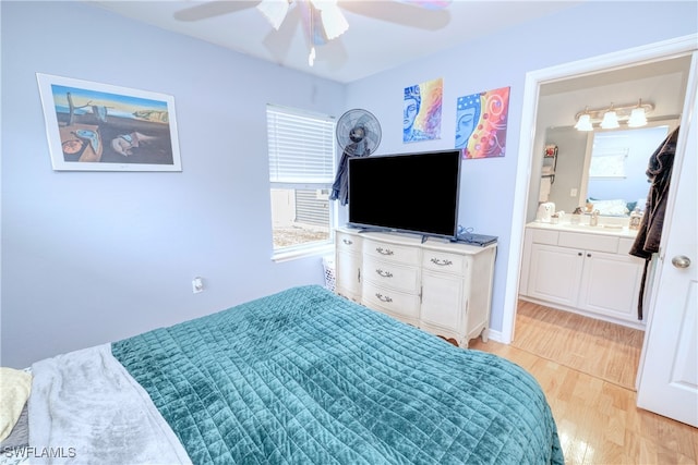 bedroom featuring ensuite bathroom, light wood-type flooring, and ceiling fan