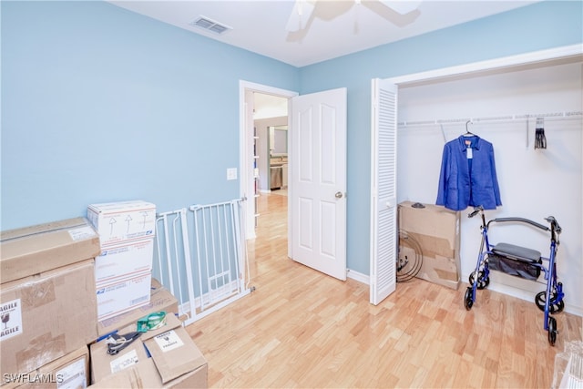 bedroom with a closet, ceiling fan, and light wood-type flooring