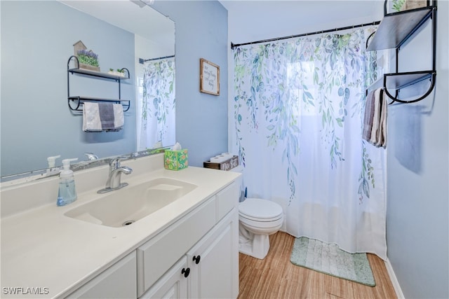 bathroom featuring vanity, toilet, a shower with shower curtain, and hardwood / wood-style floors