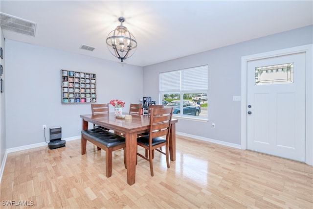 dining room featuring light hardwood / wood-style floors and a chandelier