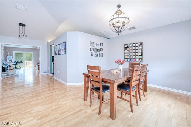 dining room featuring a notable chandelier and light wood-type flooring