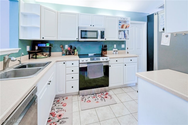 kitchen with white cabinetry, light tile patterned floors, stainless steel appliances, and sink