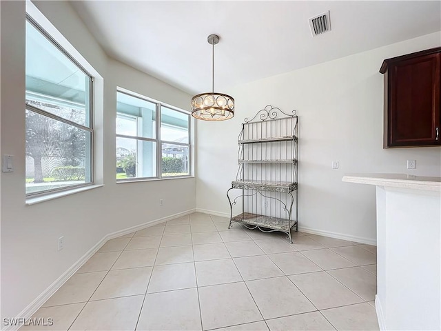 3452 Via Montana Way N, Fort Myers, FL 33917 - dining room with baseboards, a chandelier, visible vents, and light tile patterned floors