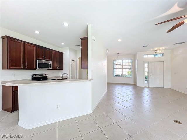 3452 Via Montana Way N, Fort Myers, FL 33917 - kitchen with stainless steel appliances, baseboards, visible vents, a ceiling fan, and light tile patterned floors