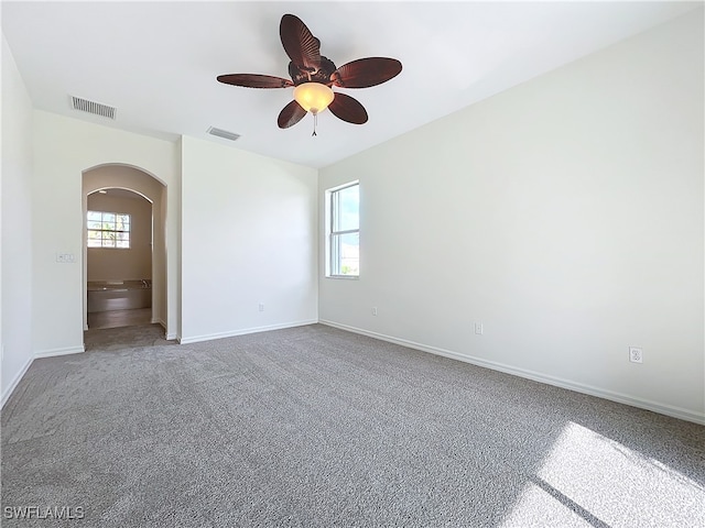 empty room with ceiling fan and carpet floors