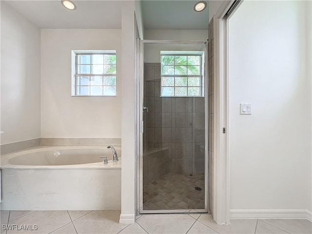 bathroom featuring tile patterned floors, separate shower and tub, and a wealth of natural light