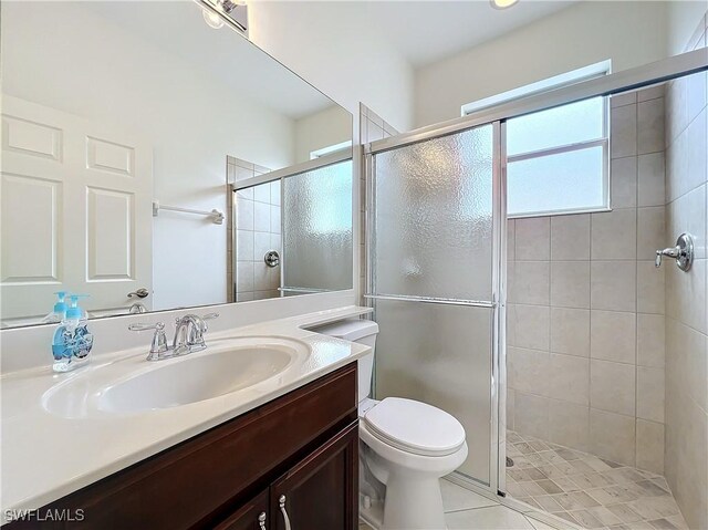 3452 Via Montana Way N, Fort Myers, FL 33917 - full bathroom featuring toilet, vanity, tile patterned flooring, and a stall shower