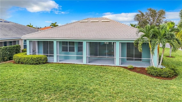 3452 Via Montana Way N, Fort Myers, FL 33917 - back of property with a lawn, a tiled roof, a sunroom, and stucco siding