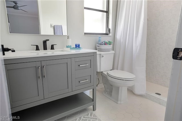 bathroom featuring toilet, a shower with curtain, tile patterned floors, ceiling fan, and vanity