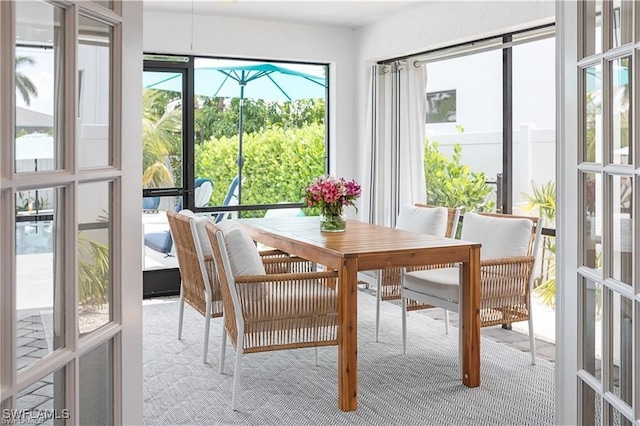 sunroom / solarium featuring french doors