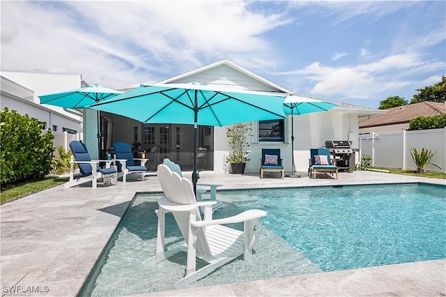 view of swimming pool featuring grilling area and a patio