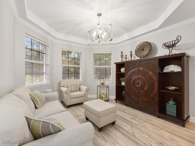 living room featuring a tray ceiling and light wood-type flooring