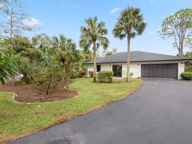 view of front facade with a garage and a front lawn