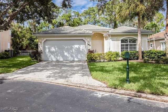 view of front of property featuring a front yard and a garage