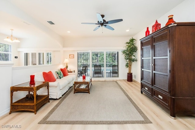 living room with ceiling fan, light hardwood / wood-style flooring, and a wealth of natural light