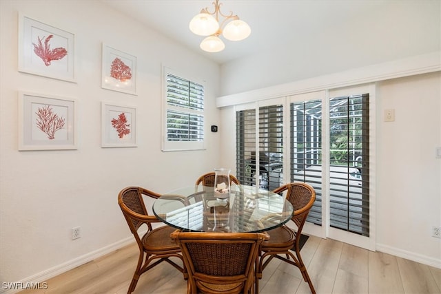 dining room with a notable chandelier and light hardwood / wood-style flooring