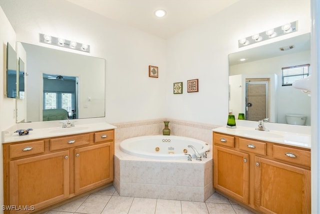 full bathroom with a healthy amount of sunlight, vanity, toilet, and independent shower and bath