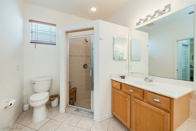 bathroom featuring vanity, tile patterned flooring, toilet, and a shower with door