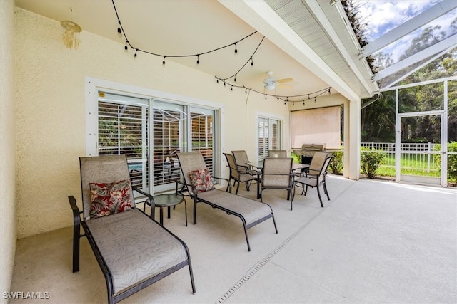 view of patio featuring a lanai